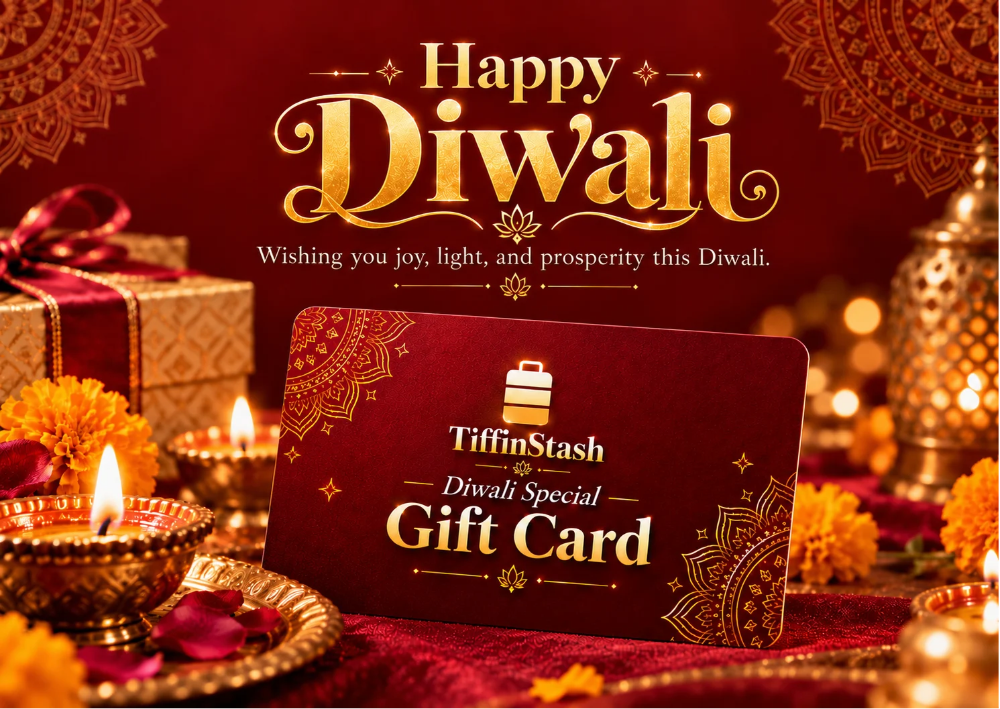 A TiffinStash Diwali Special Gift Card displayed in a festive setting with lit diya lamps, marigold flowers, and traditional Indian decor. The background features a large 'Happy Diwali' greeting in gold lettering on a deep red backdrop.