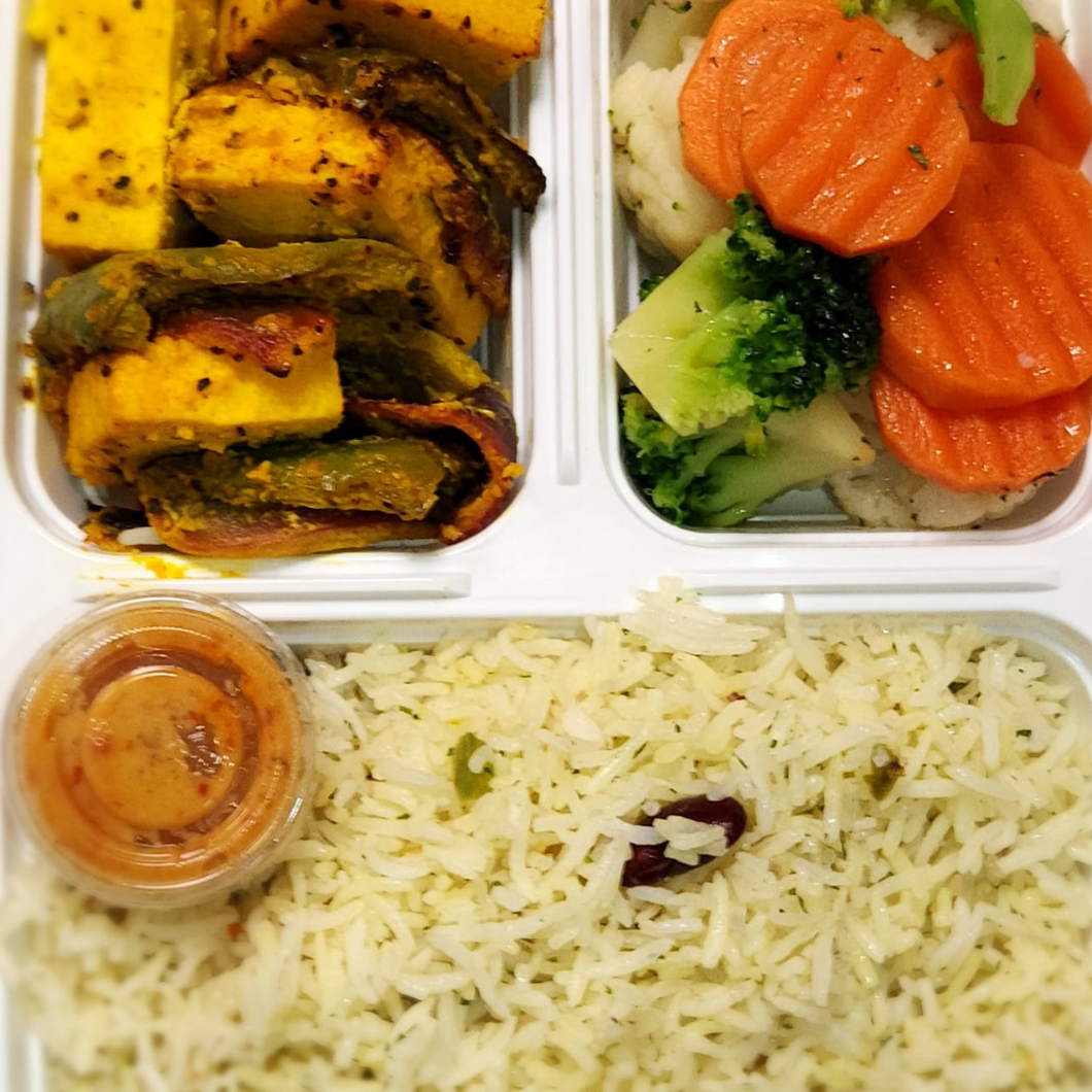 Grilled paneer rice bowl from Tiffin Stash - Veg Healthy Meals by India's Flavour with seasoned paneer, mixed vegetables, and basmati rice.