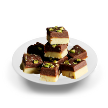 Load image into Gallery viewer, Assorted chocolate and vanilla fudge pieces on a white plate with a white background
